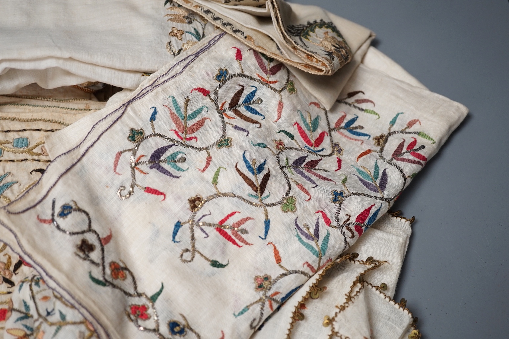 A collection of 19th century Turkish towels and runners, etc., embroidered with gold and silver and polychrome threads
